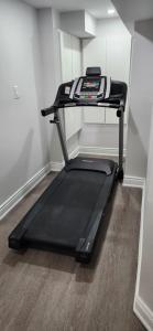 a treadmill sitting on the floor in a room at Cozy 2 Bedrooms & 2 Bathrooms Guest Suite with Electric Fireplace in Georgetown