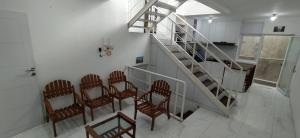a group of chairs in a room with a staircase at Rumah Bahagia 36 in Bonorejo