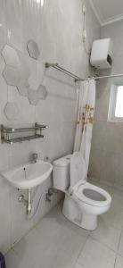 y baño con aseo y lavamanos. en Rumah Bahagia 36, en Bonorejo