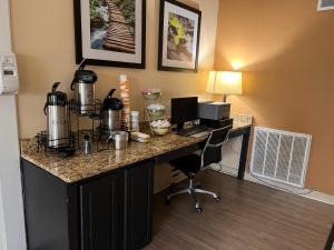 a desk in a hotel room with a computer on it at Quality Inn in Maysville