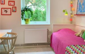 sypialnia z różowym łóżkiem i oknem w obiekcie Beautiful Home In Bohus-bjrk With Wifi w mieście Skarvik