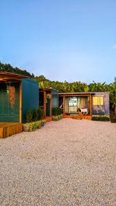 a house with a gravel yard in front of it at Container com clima de montanha! in Siderópolis