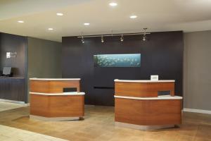 a lobby with two counters and a painting on the wall at Courtyard by Marriott Glassboro Rowan University in Glassboro