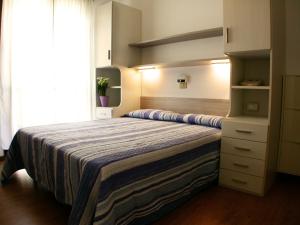 a bedroom with a large bed and a large window at Albergo Aquila in Lido di Jesolo