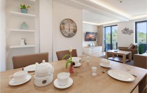 a dining room with a table and a clock on the wall at Eden in Binz