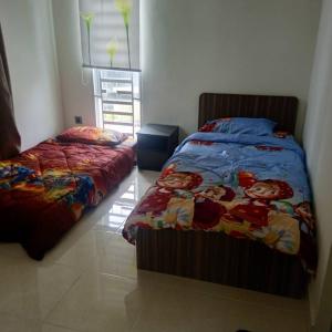 a bedroom with two beds in a room at Pro-Qaseh Room Stay , Darulaman Lake Home in Jitra