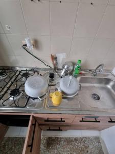 um lavatório de cozinha com panelas e frigideiras em Aparta estudio bonito, independiente bien ubicado em Bogotá