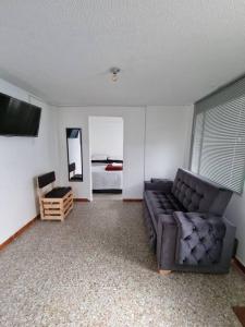 a living room with a couch and a bed at Aparta estudio bonito, independiente bien ubicado in Bogotá