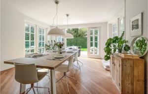 uma sala de jantar com uma grande mesa de madeira e cadeiras em Lovely Home In Holten With Wifi em Holten