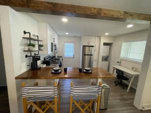 a kitchen with a large wooden table and chairs at Modern ~ Comfortable ~ Downtown, Queen beds, Bikes in Greenville