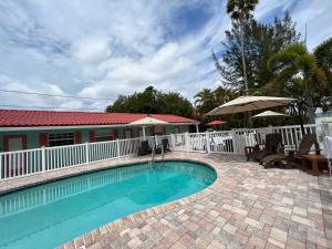 a swimming pool in front of a house at Blue Waters Treasure Island in Treasure Island