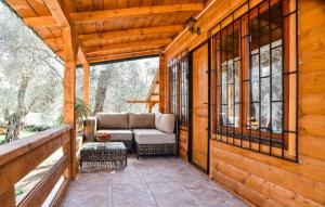 a porch of a log cabin with a couch at Chalet Mediterraneo in Ulcinj