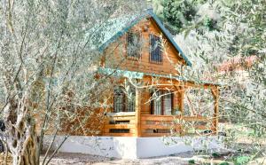 a log cabin in the woods with trees at Chalet Mediterraneo in Ulcinj
