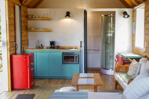 a kitchen with blue cabinets and a red refrigerator at Chalet Santa Clara in Jericó