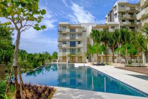 a swimming pool in front of a building at BY THE SEA - Penthouse 3 bedroom in Batu Ferringhi