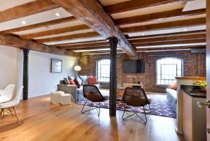 a living room with a brick wall at Wild Roses Serviced Apartments - ExCel Warehouse 1 in London