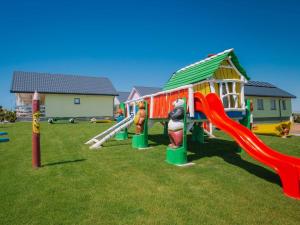 a playground with a slide and a play house at Cottage in Bobolin near Sandy Beach in Bobolin