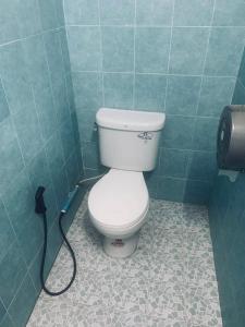 a bathroom with a toilet with a hose at The Black Sheep Hostel in Haad Rin