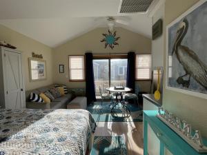 a bedroom with a bed and a living room at NC 12 56821-7 Condo in Hatteras