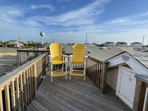 two yellow chairs sitting on a deck at NC 12 56821-7 Condo in Hatteras