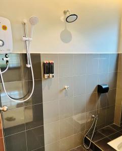 a shower in a bathroom with a shower head at Inn Homestay in Teluk Intan