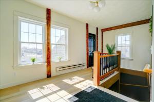 an empty living room with a staircase and windows at 205 - Queen Suite in Waunakee