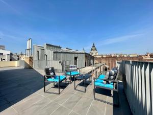a balcony with chairs and a view of a city at Penthouse w Private Rooftop and Free parking in Budapest