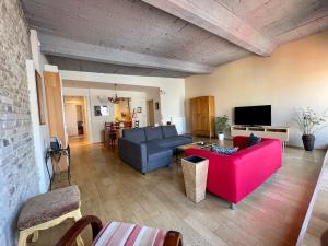 a living room with two couches and a tv at Penthouse w Private Rooftop and Free parking in Budapest