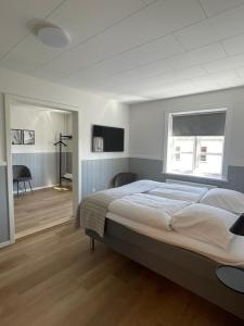 a bedroom with a large bed and a window at Annex in Frederikshavn