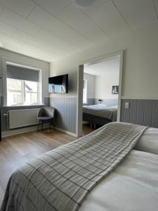 a bedroom with a large bed and a mirror at Annex in Frederikshavn