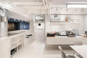 a large kitchen with white counters and blue cabinets at Speck Bangkok in Bangkok