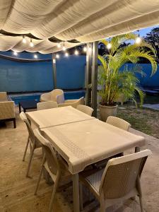 a white table and chairs under a tent at La Coqueta in Herradura