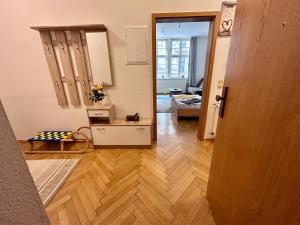 a living room with a wooden floor and a hallway at Piano Apartment in Halle Center - Netflix - Free WiFi 1 in Halle an der Saale