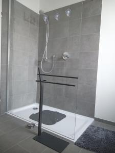a bathroom with a shower with a glass door at Ferienwohnung Haus Knäppen Size M in Oelde