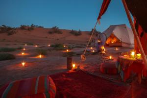 a tent in the middle of the desert at night at Bivouac Exclusif "Les Hommes Bleu"-Dar Azawad in Mhamid