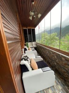 a room with couches in a room with windows at Uzungöl Özkan Pansiyon in Uzungöl