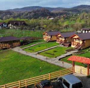 an aerial view of a farm with a fence and houses at Baltina Parc Transfagarasan in Curtea de Argeş