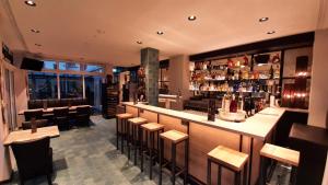 a restaurant with a bar with stools at Hotel Krupp in Bad Neuenahr-Ahrweiler