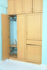 a pair of wooden cupboards in a room at Jiji Homes 1 Bedroom house with Wi-Fi king size bed. Free parking in Naivasha