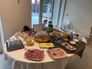 a table with many different types of food on it at Villa Veronesi in San Martino della Battaglia