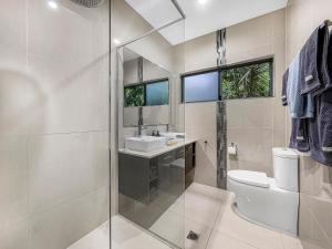 a bathroom with a shower and a toilet and a sink at Casa Mia Retreat Luxury Family Home on Buderim in Buderim +32 photos
