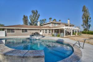 a large swimming pool in front of a house at Casa Rosé in Temecula