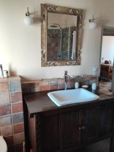 La salle de bains est pourvue d'un lavabo et d'un miroir. dans l'établissement Petit cocon à Mourepiane, à Marseille