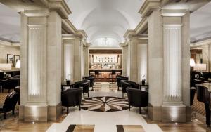a bar with chairs and tables in a building at Majestic Hotel & Spa Barcelona GL in Barcelona