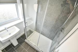 a bathroom with a shower and a sink at Dalkeith House By Horizon Stays in Hartlepool