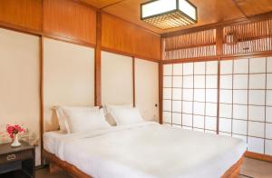 a bedroom with a white bed in a room at Hokke Lumbini in Rummindei