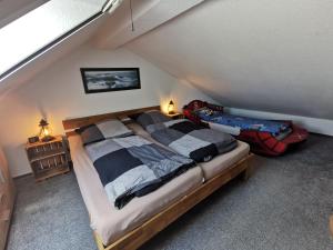 - une chambre mansardée avec un grand lit dans l'établissement Fewo Dorumer Piratennest, à Dorum Neufeld