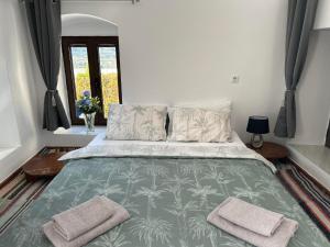 a bedroom with a bed with two towels on it at New Lindos Studio 45 renovated in Lindos