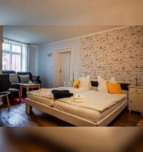 a bedroom with a bed and a brick wall at Hotelpension Pfarrhaus in Alt Schwerin