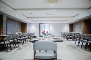 una sala da pranzo con tavoli e sedie in una stanza di Hotel Tulips Grand a Hyderabad